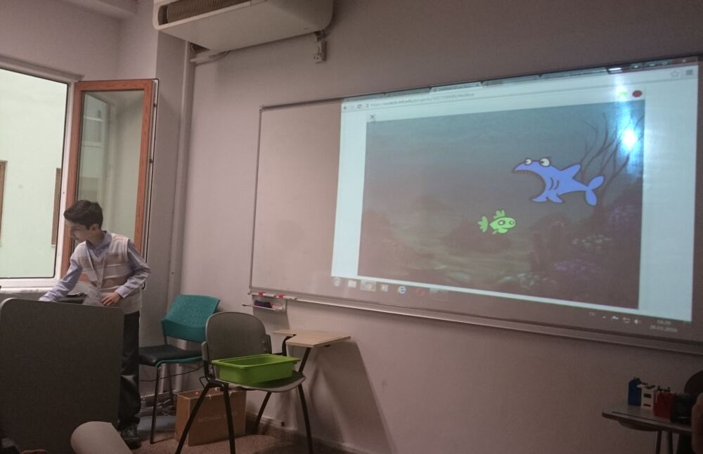 Batu presenting a Scratch project on a classroom projector at Yeditepe University in 2016